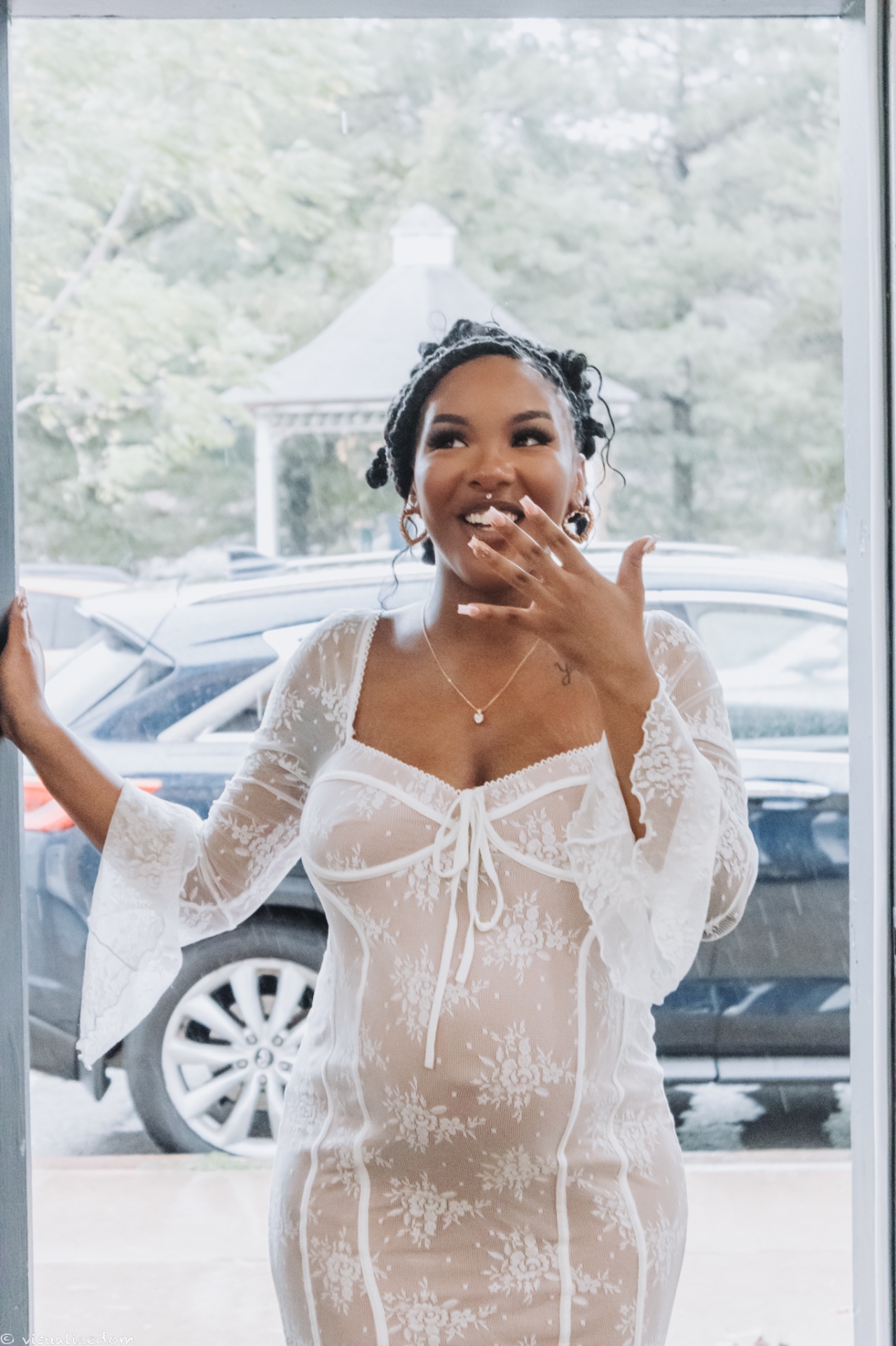Elegant portrait of a woman in a white lace dress with soft natural lighting