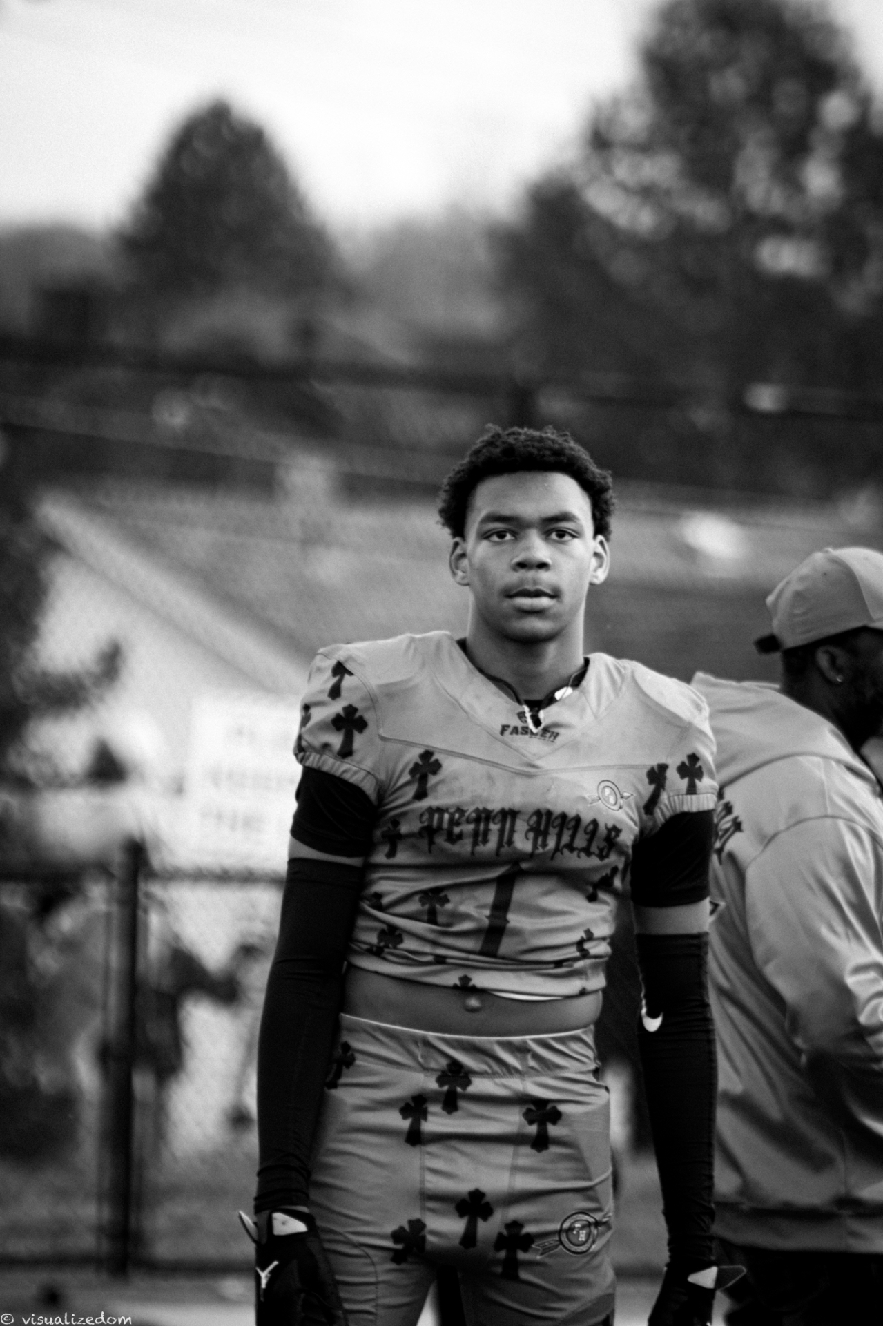 Dramatic black and white portrait of a football player in full pads